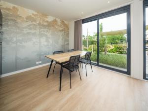 a dining room with a table and chairs at Harderwold Villa - 228 in Zeewolde