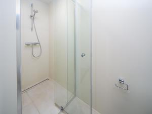 a shower with a glass door in a bathroom at Harderwold Villa - 228 in Zeewolde +9 photos