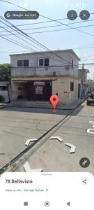 a red object in the street next to a building at Habitaciones Bellavista 115 in Ciudad del Carmen