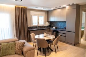 a kitchen and living room with a table and chairs at Olive Home in Alexandroupoli