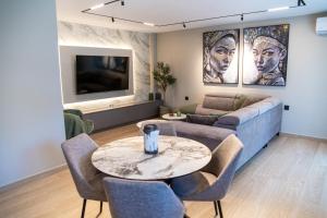 a living room with a couch and a table at Olive Home in Alexandroupoli