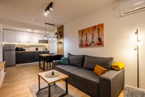 a living room with a couch and a kitchen at Surčin Central Stay in Surčin +102 photos