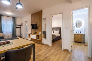 a living room with a bed and a table at Surčin Central Stay in Surčin