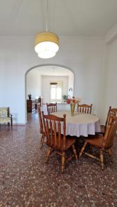 a dining room with a table and chairs at Pabula Vernatica Salento in San Pietro Vernotico +9 photos