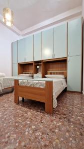 a large room with two beds and cabinets at Pabula Vernatica Salento in San Pietro Vernotico