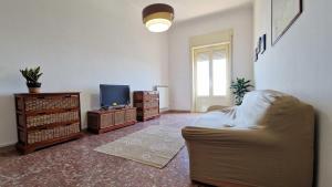 a living room with a couch and a tv at Pabula Vernatica Salento in San Pietro Vernotico