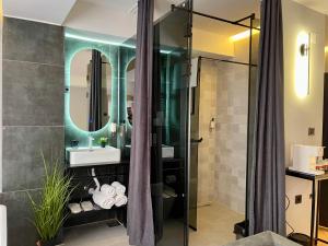 a bathroom with a shower and a sink at XIX Boutique Apartment in Skopje