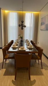 a large dining room table with chairs and a long table at اصيلة فيلا Asilah Villa in Buraydah