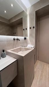 a bathroom with a sink and a large mirror at Olive Home in Alexandroupoli +32 photos