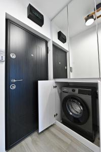 a laundry room with a washer and dryer at Lili's Studio 2 in Piteşti