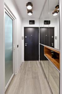a hallway with a black door and a closet at Lili's Studio 2 in Piteşti