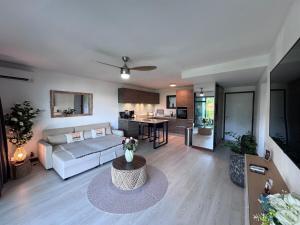 a living room with a couch and a table at Your Tahiti Escape in Faaa