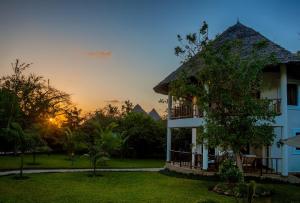 a villa with a view of a building at Villa Kapungu with private C h e f, XXL pool & garden in Diani Beach