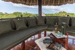 a couch sitting on top of a table at Villa Kapungu with private C h e f, XXL pool & garden in Diani Beach