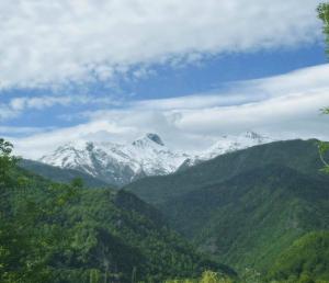 a mountain range with snow capped mountains in the distance at Rachnari Guest House in Gari