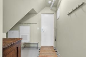 a hallway with a door and a bench at Central Top Floor Apartment in Stavanger +5 photos