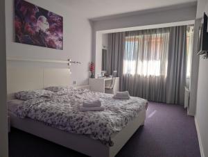 a bedroom with a bed with two towels on it at Violet Stay in Skopje