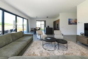 a living room with a couch and a table at Maan Nr. 301 | 10 Pers. Hottub in Zeewolde