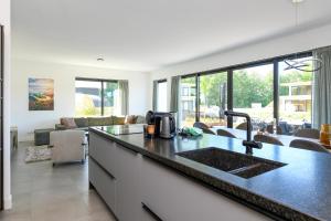 a kitchen with a sink and a counter top at Maan Nr. 301 | 10 Pers. Hottub in Zeewolde +30 photos
