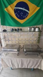 a flag of brazil and two tables in front of a flag at Borba Beach House in Recife +73 photos