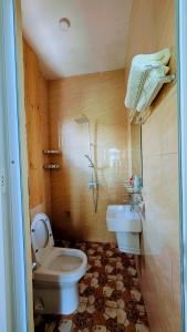 a bathroom with a toilet and a sink at Esther & Hans Homes in Dodoma +49 photos