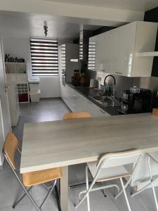 a kitchen with a large wooden table and chairs at Chez Kri in Limbourg