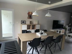 a dining room with a wooden table and chairs at Chez Kri in Limbourg