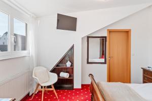 a bedroom with a bed and a desk and a chair at Scharnhäusle 15 - Guest room Ostfildern in Ostfildern