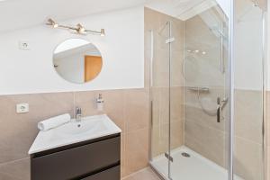 a bathroom with a sink and a shower at Scharnhäusle 15 - Guest room Ostfildern in Ostfildern