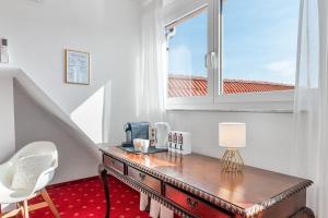 a room with a wooden table and a window at Scharnhäusle 15 - Guest room Ostfildern in Ostfildern