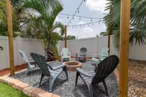 a patio with chairs and a fire pit at Pink Flamingo in Clearwater