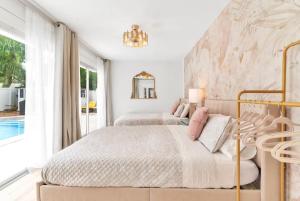 a white bedroom with two beds and a pool at Pink Flamingo in Clearwater +52 photos