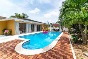 a swimming pool in the backyard of a house at Pink Flamingo in Clearwater