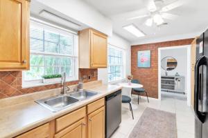 a kitchen with wooden cabinets and a sink at Pink Flamingo in Clearwater