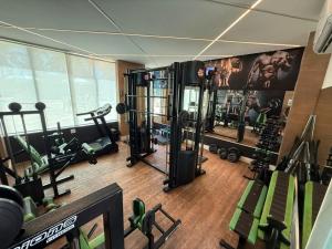 a gym with several treadmills and other equipment at Camboflat in Niterói