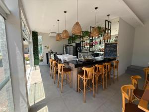 a restaurant with a bar with chairs and a counter at Camboflat in Niterói
