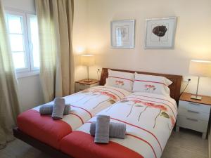 a bedroom with a bed with two pillows on it at Villa Elegante, with a private pool in Murcia +36 photos