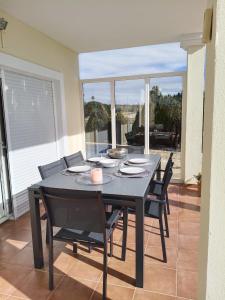 a dining room with a black table and chairs at Villa Elegante, with a private pool in Murcia