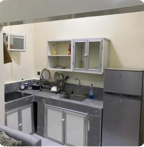 a kitchen with a sink and a refrigerator at ESSERa in Nouakchott