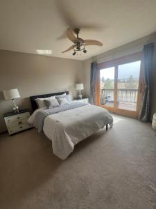 a bedroom with a bed and a ceiling fan at Bayou Hills BnB in Parker