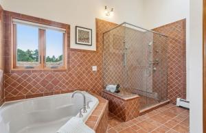 a bathroom with a tub and a glass shower at Bayou Hills BnB in Parker +20 photos
