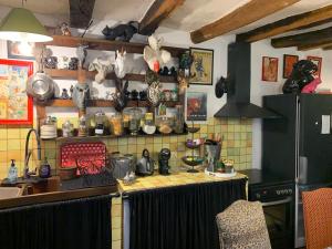 a kitchen with a counter top withanimal heads on the wall at Maison de charme du 18 e s de centre ville in Sablé-sur-Sarthe