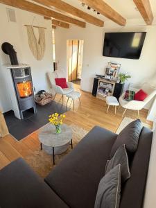 a living room with a couch and a wood stove at OdpocznieszTU in Brzozowa