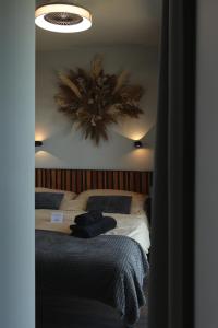 a bedroom with a bed and a large mirror at Ateliéry Nad Závozom in Hrušov +119 photos