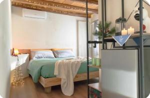 a bedroom with a bed with a green comforter at GIAMI affittacamere & SPA in Santa Giustina