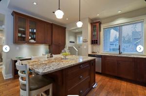 a kitchen with a large island with a counter top at Qualicum Landing Coastal Cottage in Qualicum Beach