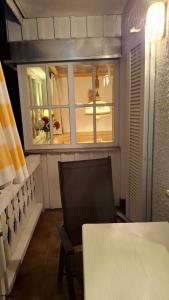 a room with a table and a chair and a window at Stadthaus Sonneneck in Bad Tölz