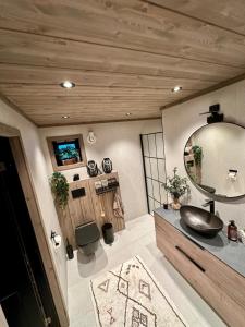 a bathroom with a sink and a mirror at Cabin with sea view in Moen