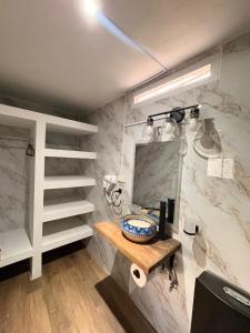 a bathroom with a sink and a mirror at Naab apart complex in Panajachel +27 photos