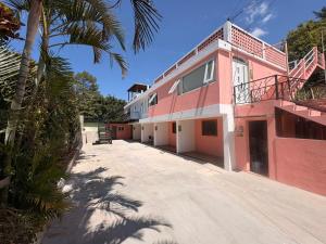 a pink building with a balcony on top of it at Naab apart complex in Panajachel